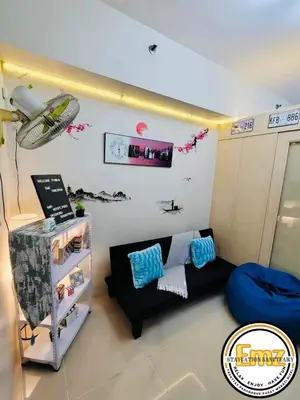 a living room with a couch and a table at EMZ JAZZ Staycation in Manila