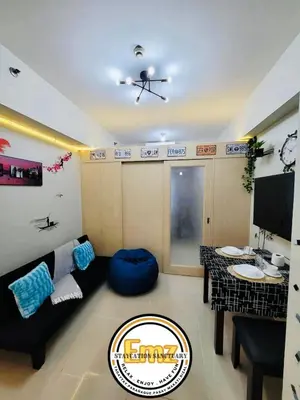 a living room with a couch and a table at EMZ JAZZ Staycation in Manila