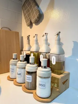 a group of bottles on a shelf in a kitchen at The Scandi Hub at Air Residences, Makati in Manila