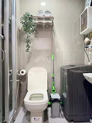 a small bathroom with a toilet and a sink at The Scandi Hub at Air Residences, Makati in Manila