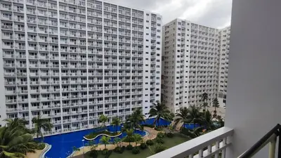 a view of a large building with a swimming pool at Shore Residences - 1BR Breezy Home Near the Sea in Manila