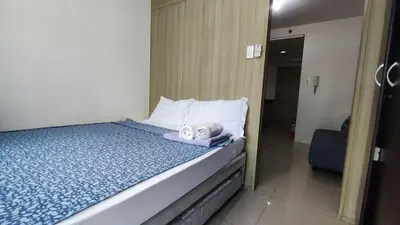 a bedroom with a bed with a towel on it at Shore Residences - 1BR Breezy Home Near the Sea in Manila