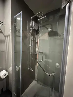a shower with a glass door in a bathroom at The Auberge at Air Residences Makati! in Manila