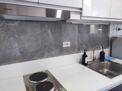 a kitchen with a sink and a counter top at The Auberge at Air Residences Makati! in Manila