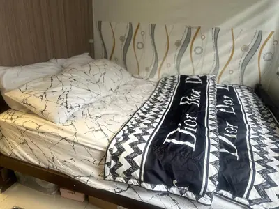 a bed with black and white comforters on it at Azhyuri staycation in Manila