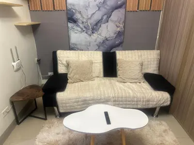 a living room with a couch and a table at Azhyuri staycation in Manila