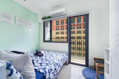 a bedroom with a bed and a large window at 1BR Staycation at Shore 2 Tower 3 in Manila