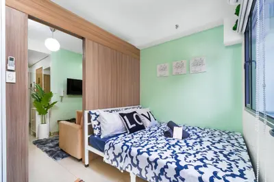 a small bedroom with a bed and a mirror at 1BR Staycation at Shore 2 Tower 3 in Manila