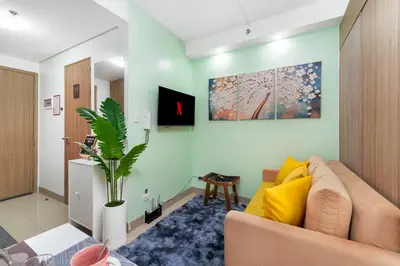a living room with a couch and a plant at 1BR Staycation at Shore 2 Tower 3 in Manila