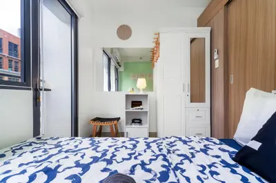 a bedroom with a bed with a blue and white comforter at 1BR Staycation at Shore 2 Tower 3 in Manila