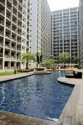 a pool in the middle of a city with tall buildings at 1BR Staycation at Shore 2 Tower 3 in Manila