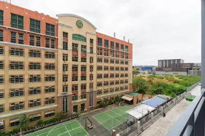 an apartment building with a tennis court in front of it at 1BR Staycation at Shore 2 Tower 3 in Manila