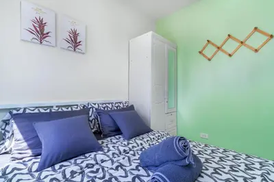 a bedroom with a bed with blue and white pillows at 1BR Staycation at S Residences Tower 1 in Manila