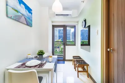 a kitchen and dining room with a table and chairs at 1BR Staycation at S Residences Tower 1 in Manila