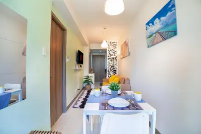 a living room with a white table and chairs at 1BR Staycation at S Residences Tower 1 in Manila
