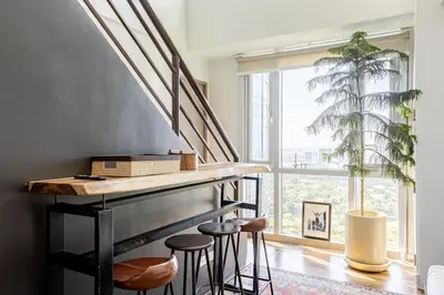 a staircase with stools and a bar in a room at Huge 101-SQM 2BR in Central BGC Up to 12 Guests in Manila