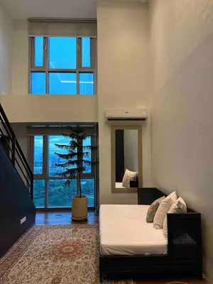 a bedroom with a bed and a tree in it at Huge 101-SQM 2BR in Central BGC Up to 12 Guests in Manila