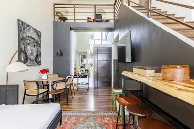 a room with a bed and a table with chairs at Huge 101-SQM 2BR in Central BGC Up to 12 Guests in Manila