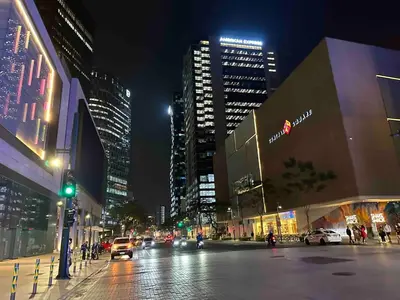 a city street at night with cars and buildings at Huge 101-SQM 2BR in Central BGC Up to 12 Guests in Manila
