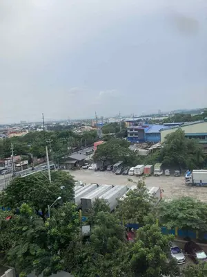 a view of a parking lot with trees and buildings at LEAF RESIDENCES MUNTINLUPA - M&G Staycation in Manila