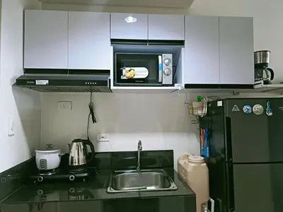 a small kitchen with a sink and a microwave at LEAF RESIDENCES MUNTINLUPA - M&G Staycation in Manila