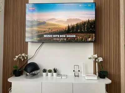 a flat screen tv hanging on a wall at LEAF RESIDENCES MUNTINLUPA - M&G Staycation in Manila