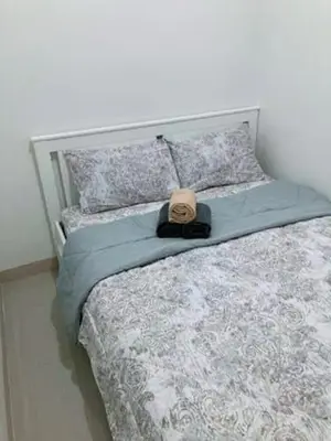 a hat sitting on top of a bed at LEAF RESIDENCES MUNTINLUPA - M&G Staycation in Manila
