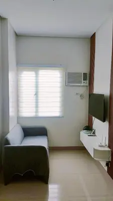 a living room with a couch and a window at LEAF RESIDENCES MUNTINLUPA - M&G Staycation in Manila