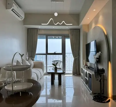 a living room with a couch and a tv at Panoramic Seaview near Airport Facing the Bay 14H in Manila