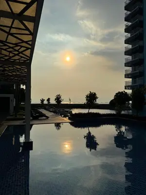 a pool of water with a sunset in the background at Panoramic Seaview near Airport Facing the Bay 14H in Manila