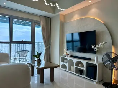 a living room with a tv and a couch at Panoramic Seaview near Airport Facing the Bay 14H in Manila
