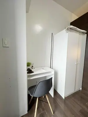 a white desk and a chair in a room at Iris Affordable and Neat Staycation at Air Residences Makati in Manila