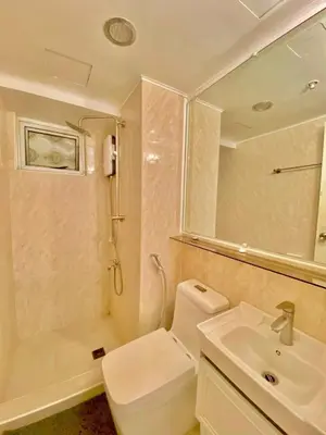 a bathroom with a toilet and a sink and a shower at Avida Towers San Lazaro in Manila
