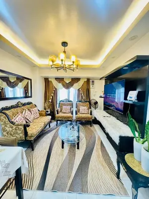a living room with a couch and a table at Avida Towers San Lazaro in Manila