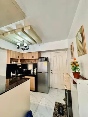 a large kitchen with a stainless steel refrigerator at Avida Towers San Lazaro in Manila