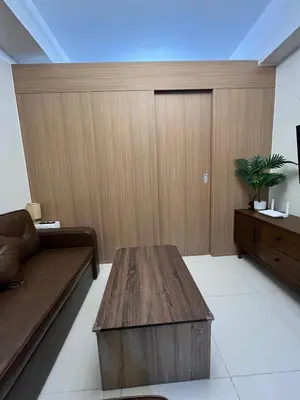 a living room with a couch and a table at Chino Roces Makati - No Parking - Red Residences in Manila