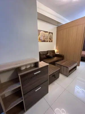 a living room with a couch and a table at Chino Roces Makati - No Parking - Red Residences in Manila