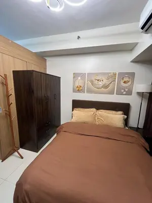 a bedroom with a large bed in a room at Chino Roces Makati - No Parking - Red Residences in Manila