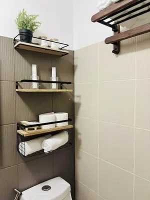 a bathroom with a toilet and some towels at Grand View Tower - Metro Stay in Manila