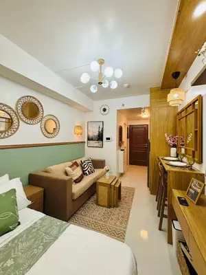 a room with a bed and a living room at Grand View Tower - Metro Stay in Manila