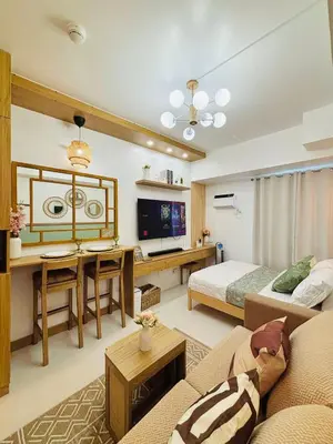 a living room with a couch and a bed at Grand View Tower - Metro Stay in Manila
