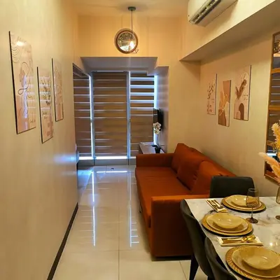 a living room with a couch and a table at Cozy Modernistic 1 BR Uptown BGC in Manila