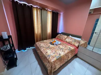 a bedroom with a bed with a stuffed animal on it at Cozy-AIS Staycation in Manila