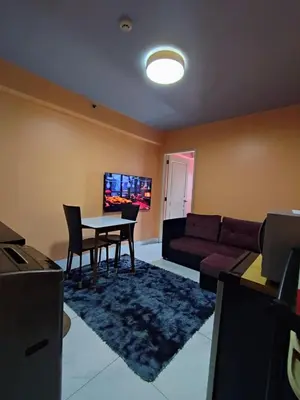 a living room with a couch and a table at Cozy-AIS Staycation in Manila