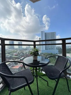 a table and chairs on a balcony with a view at The Radiance Manila Bay by SonPai in Manila