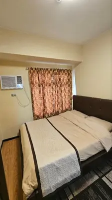 a small bedroom with a bed with a window at The Radiance Manila Bay by SonPai in Manila