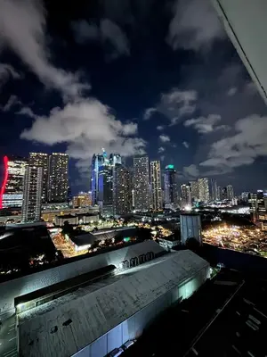 a view of a city skyline at night at Your Skyline Hideaway in Manila