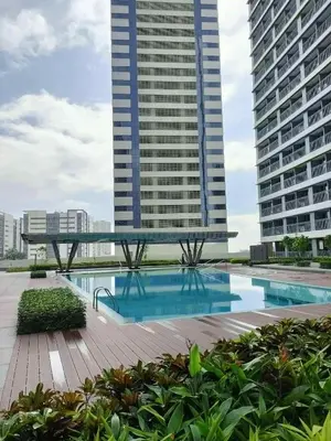 a swimming pool in the middle of two tall buildings at Your Skyline Hideaway in Manila