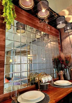 a table with plates on it with a mirror at Avida Towers Sucat in Manila