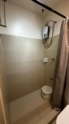 a bathroom with a shower and a toilet at SplashNStay 18sqm condi near AUP,PNPA CKS College Sta Rosa Tagaytay road Silang Cavite in Puting Kahoy
